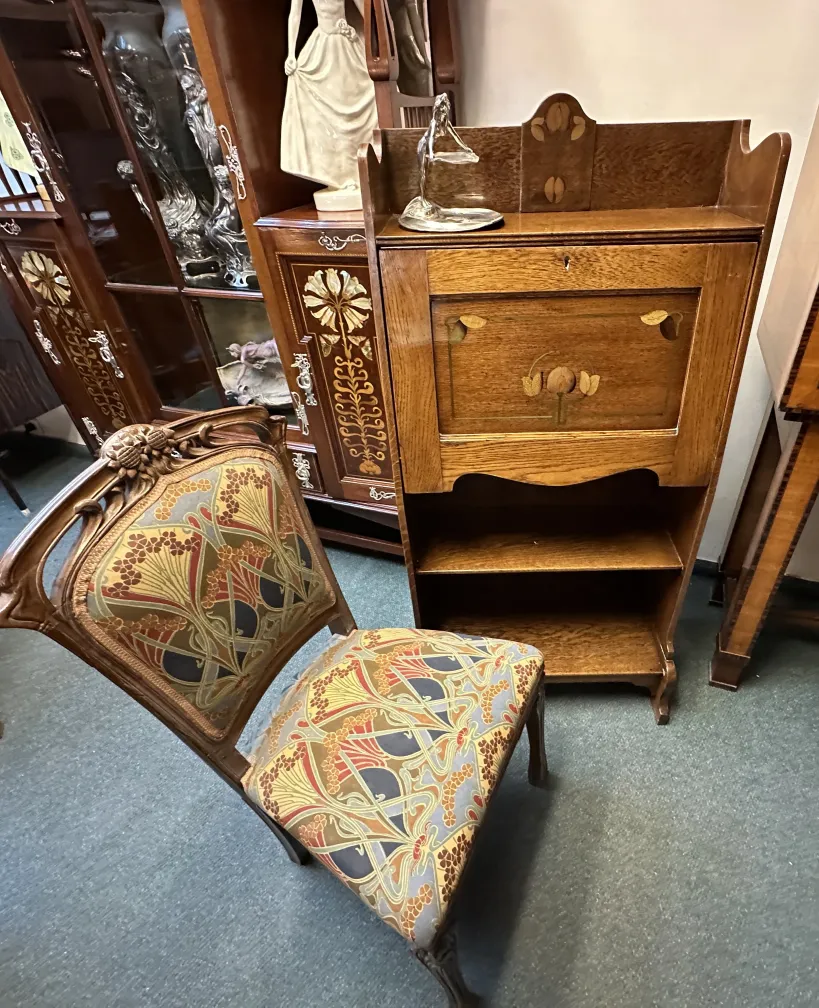 antique desk with floral carvings and elegant surroundings