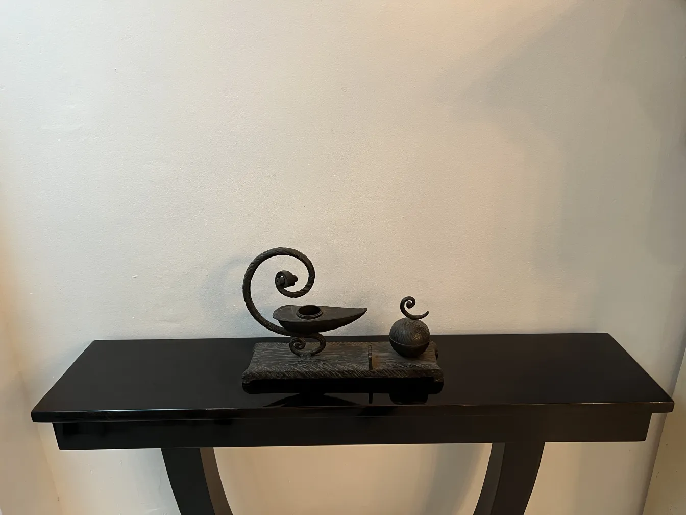 antique sculpture on a black table with soft lighting