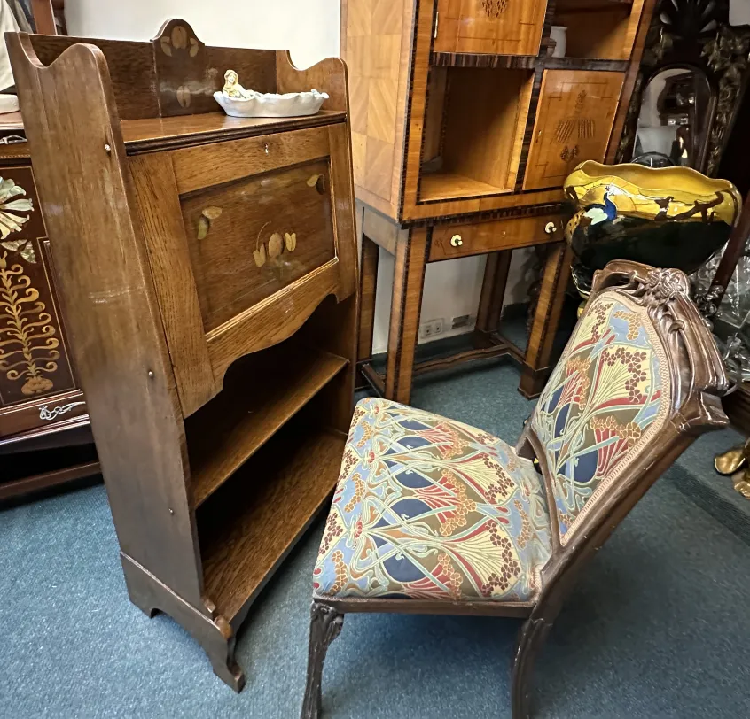 antique desk with floral design, accompanied by decorative chair in classic setting