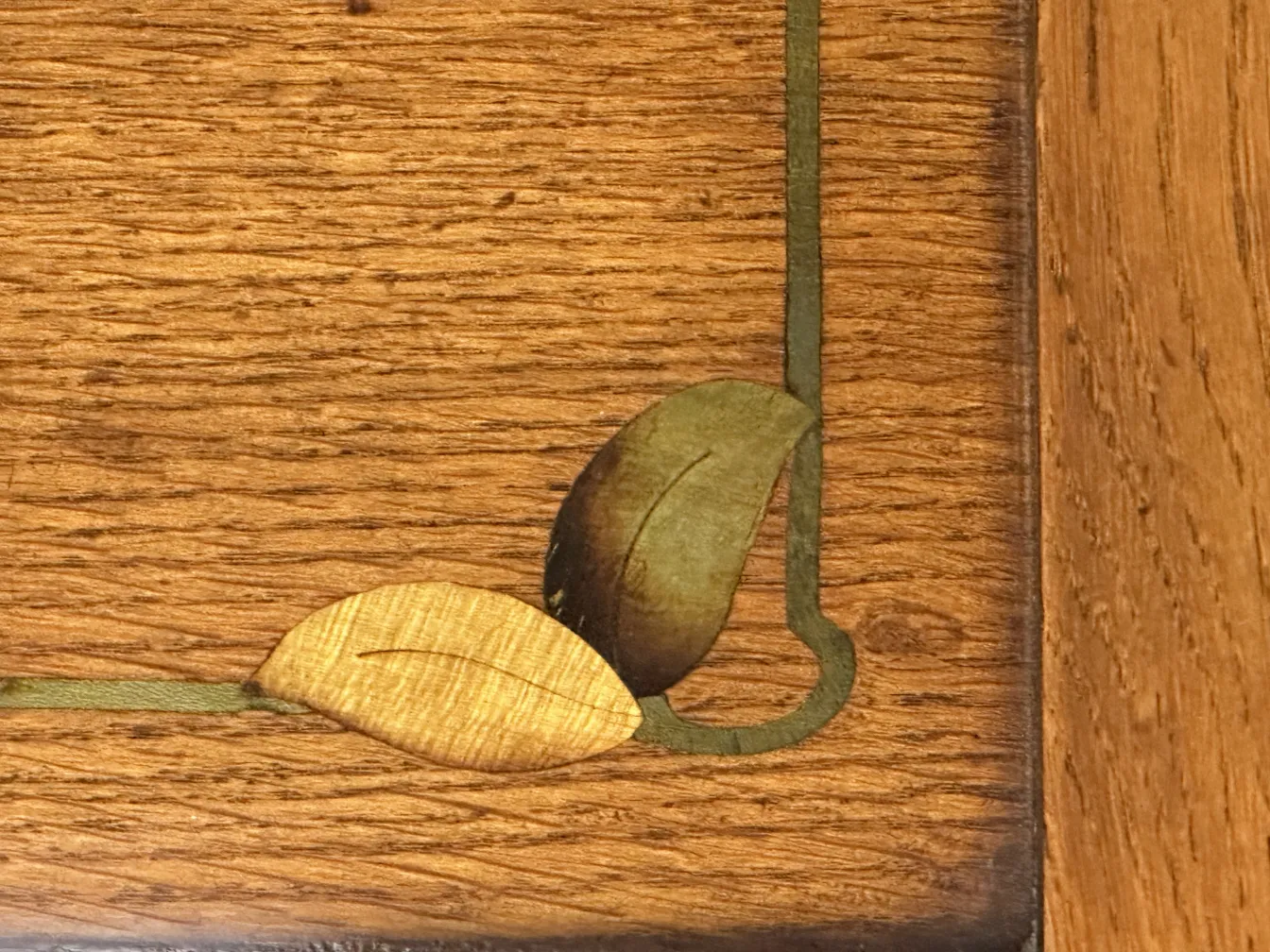 detail of an antique desk with carved leaves and clear decoration