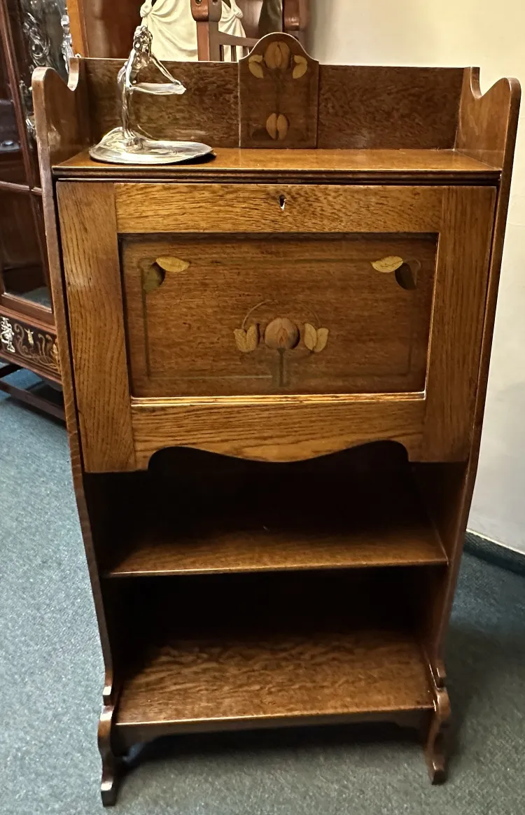 antique desk with drawer and decorative back, in a classic setting