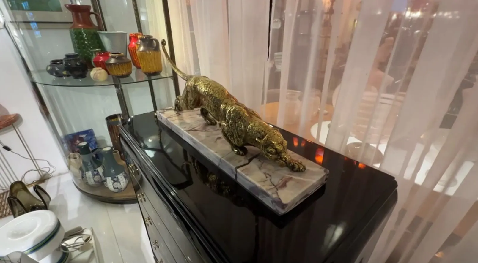 ancient sculpture of a feline on a decorative base