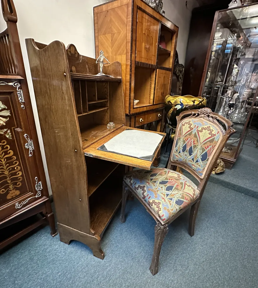 antique desk with shelves and intricate design in a decorative setting.