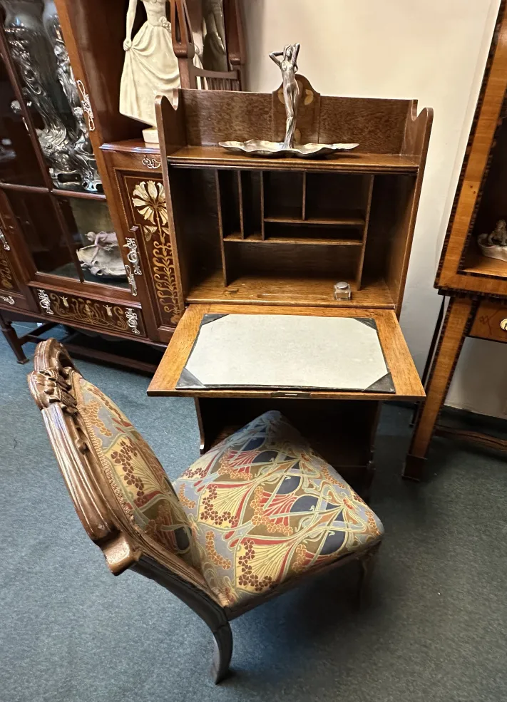 Antique desk with shelf and decorative details.