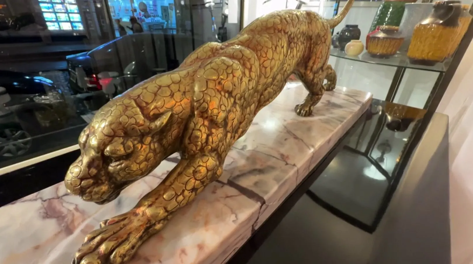 ancient golden feline sculpture on an elegant table