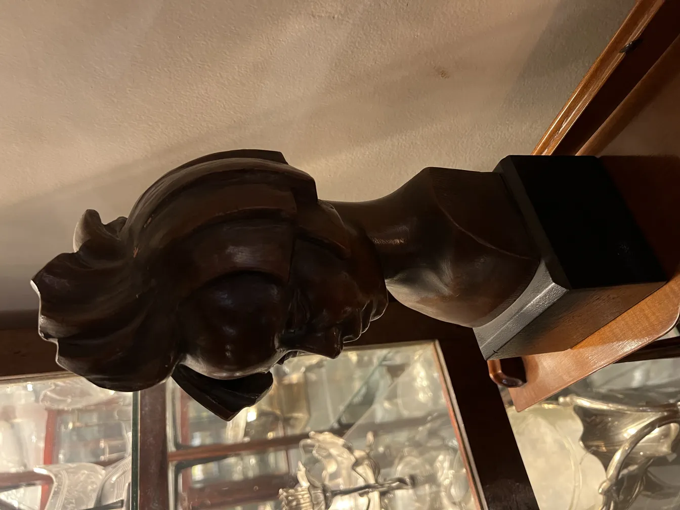 antique bust sculpture displayed with decorative details