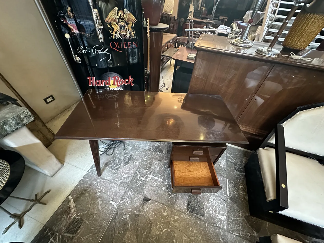 Antique wooden desk with a drawer, in an elegant setting.