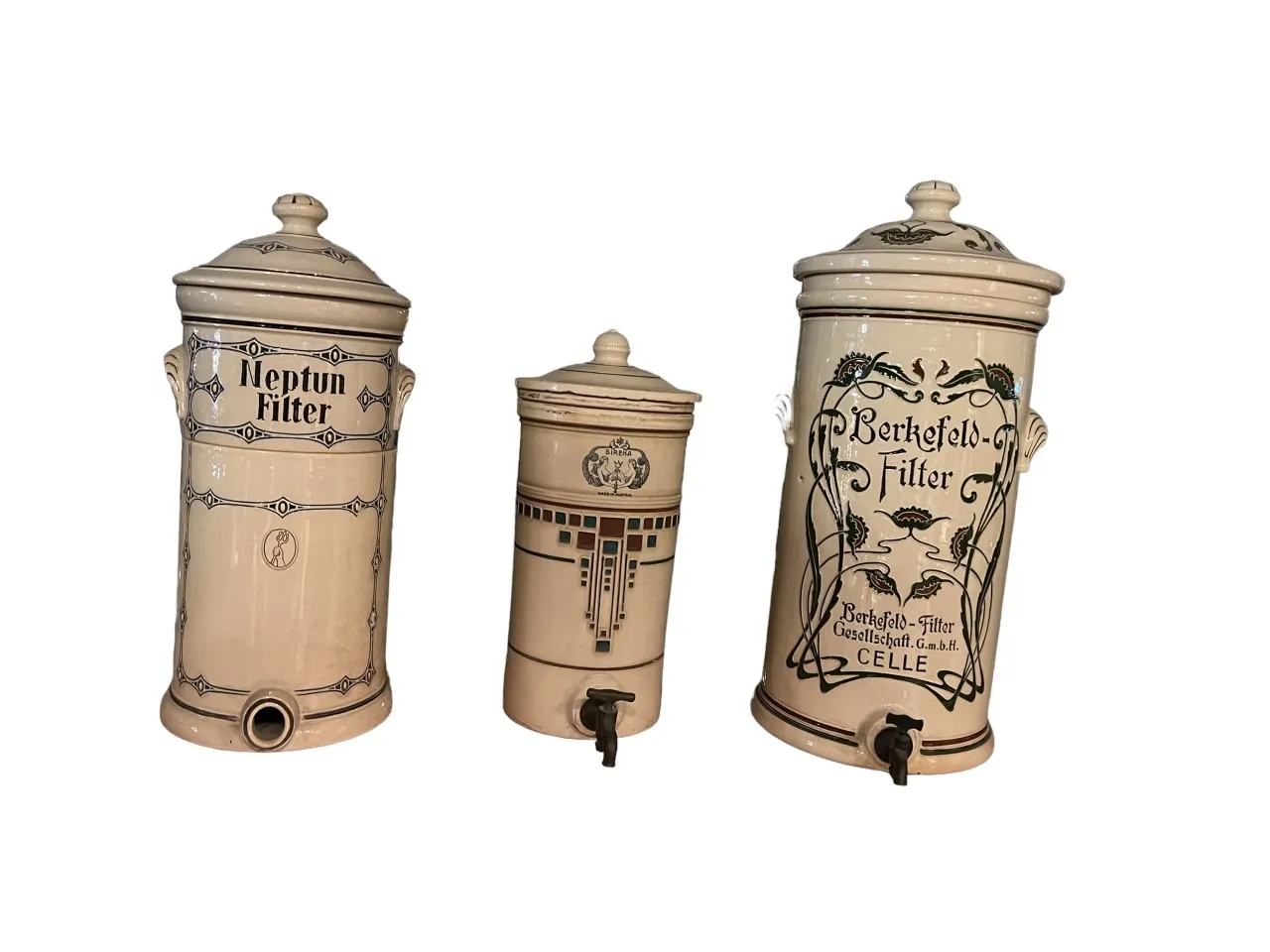 three antique ceramic water filters with lids, decorated