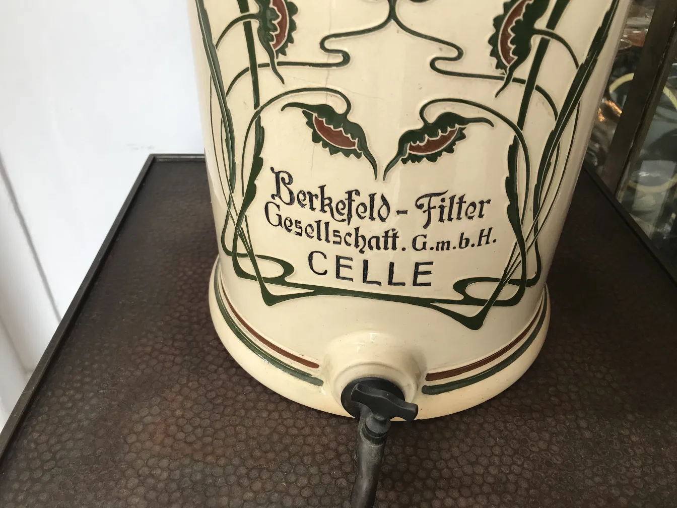 Antique ceramic decorated with colorful details and a hinge