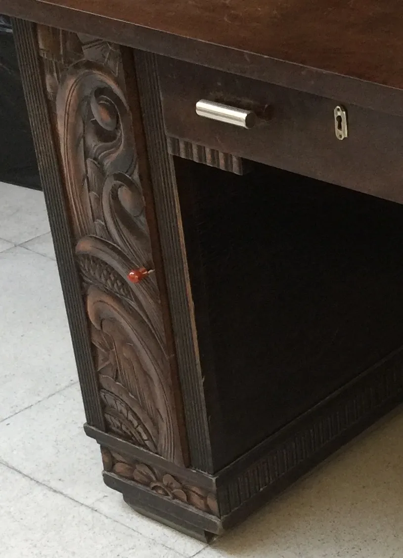 antique desk with intricate carvings and a classic setting.