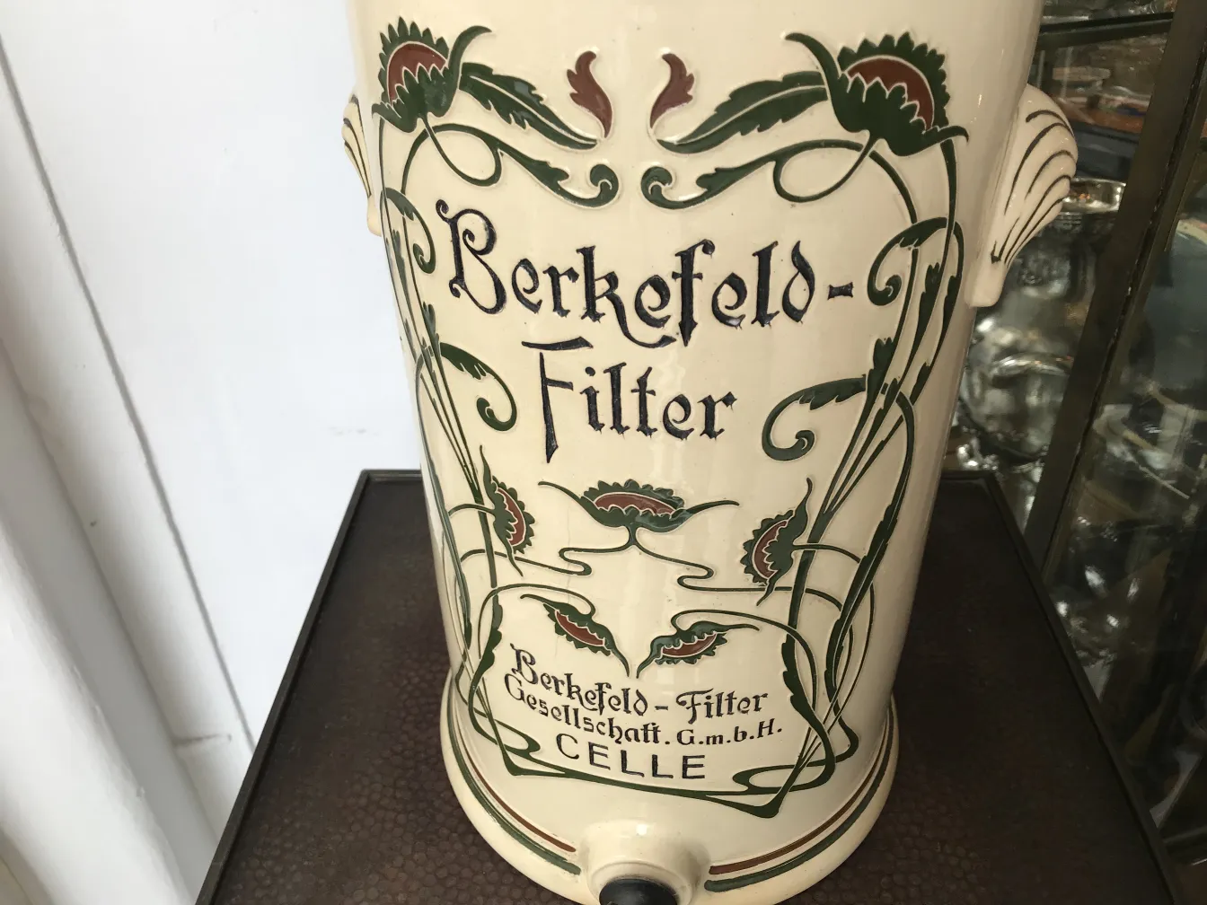 Antike Berkefeld-Keramik mit floralen Motiven und Beschriftung.