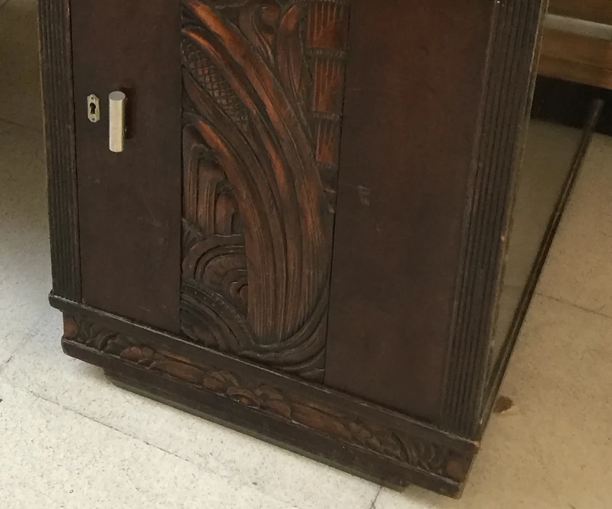 Vista de um antigo escritório com entalhes artísticos e detalhes ornamentais, ideal para decoração clássica.