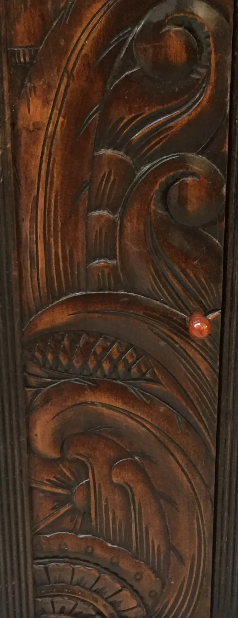 Antique desk with decorative wood carvings, dark color.