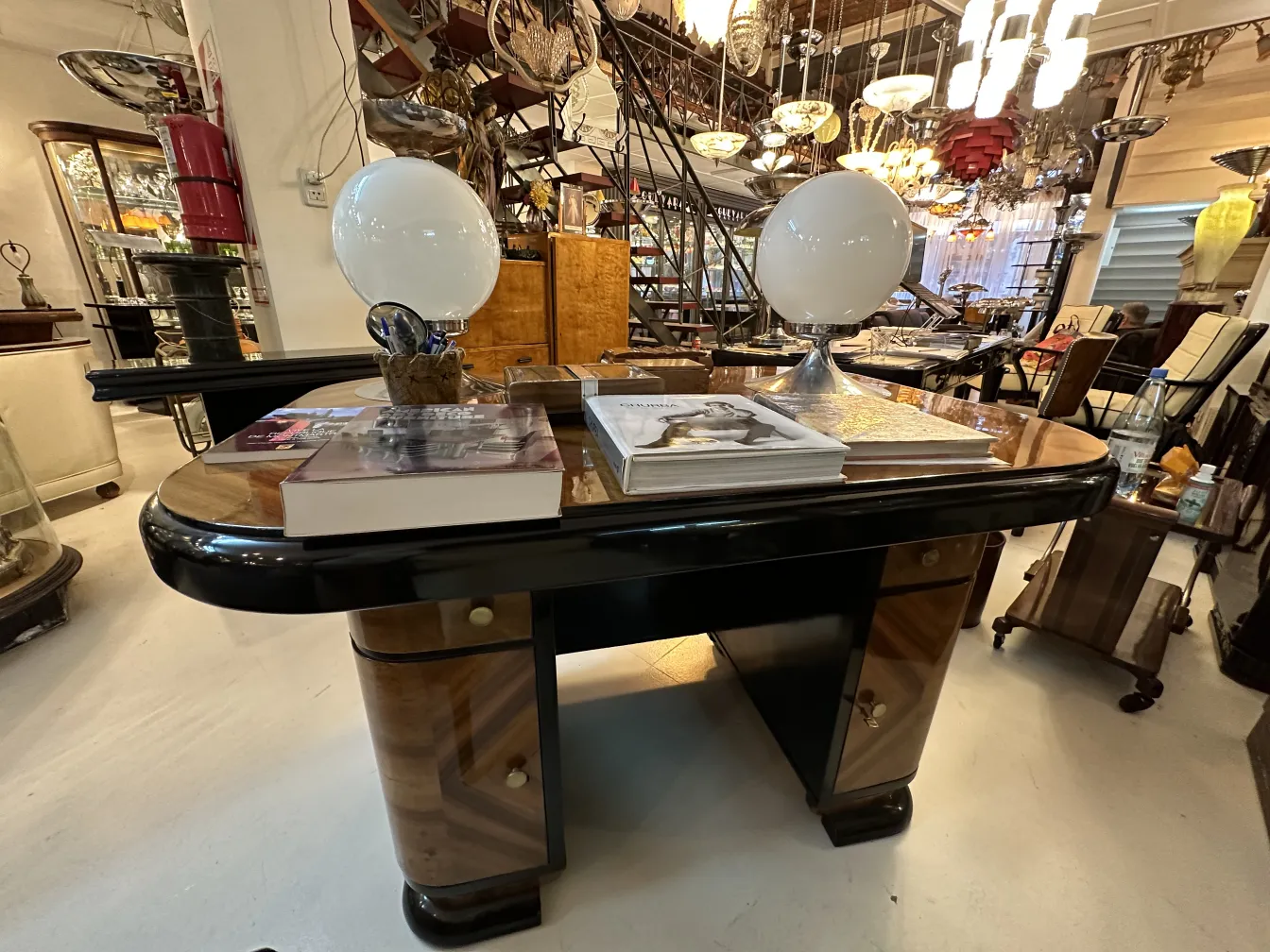 Antique desk with books and lamp on it