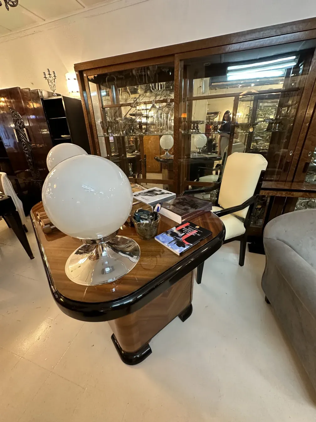 antique desk with lamp and decorative items