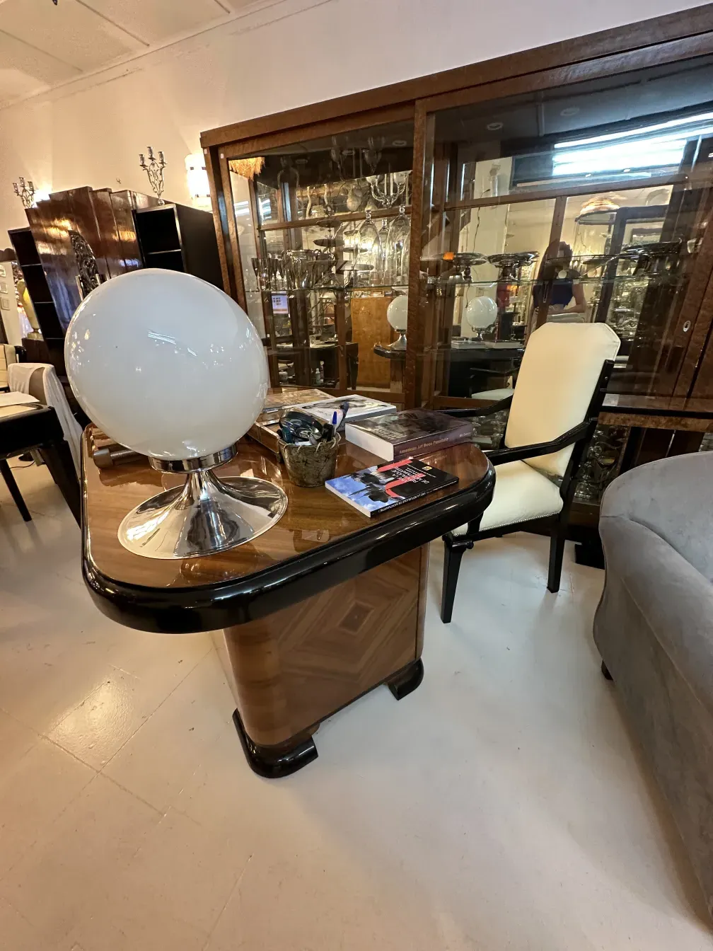 antique desk with polished surface and white lamp