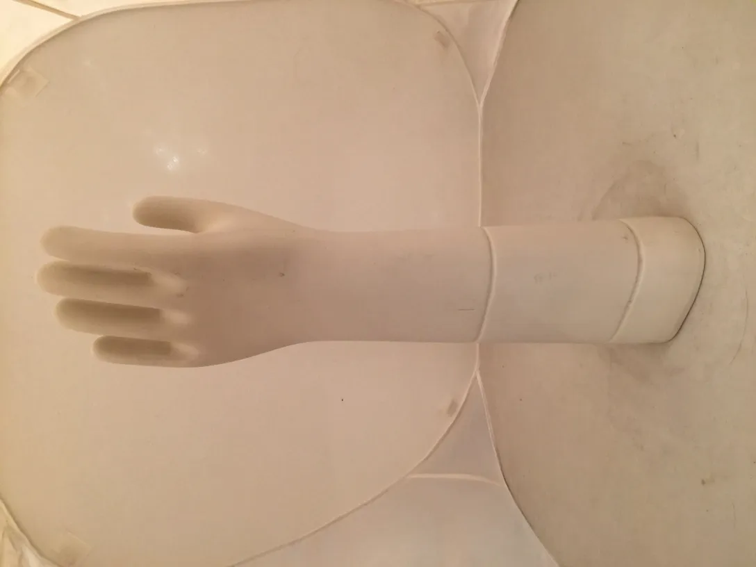 Antique ceramic hand displayed against a light background.