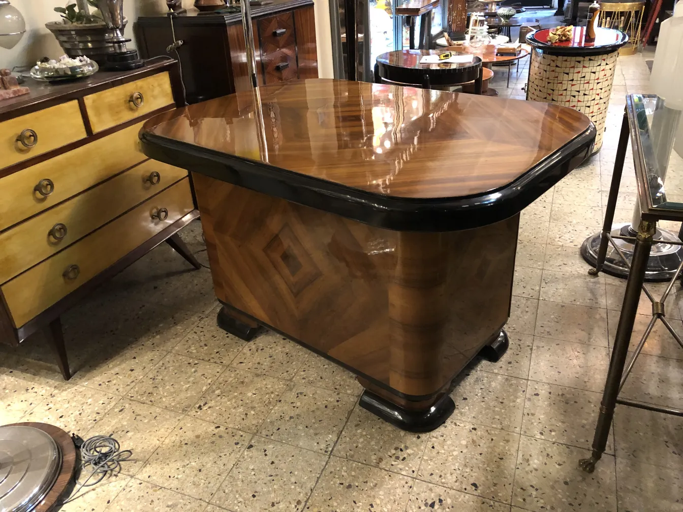 Antique wooden desk with a stylish shape, surrounded by other furniture