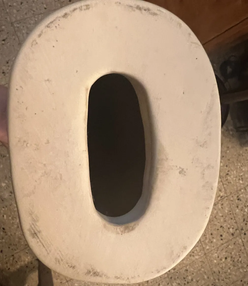 Top view of an antique ceramic with an oval opening, light texture.