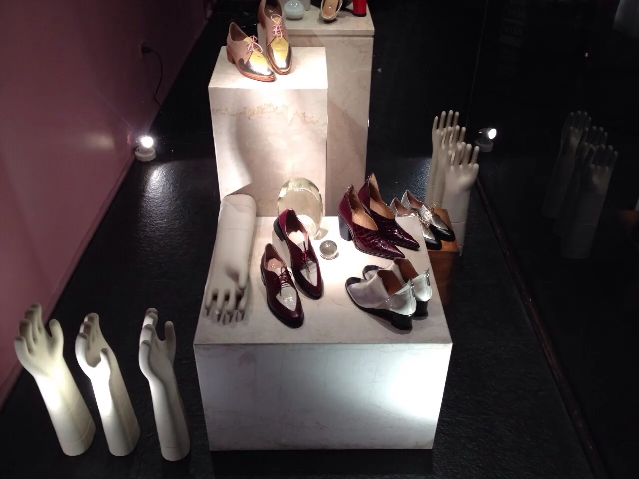 Antique ceramics displayed alongside elegant shoes.