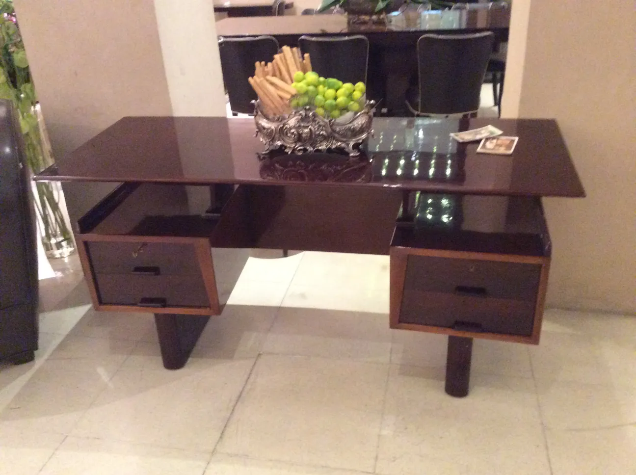 Elegant antique desk with a shiny surface and drawers. Set in a modern decor.