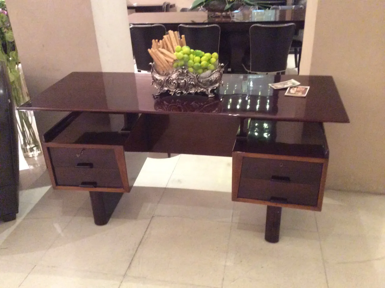 antique desk with an elegant design and two drawers, decorated with a fruit bowl