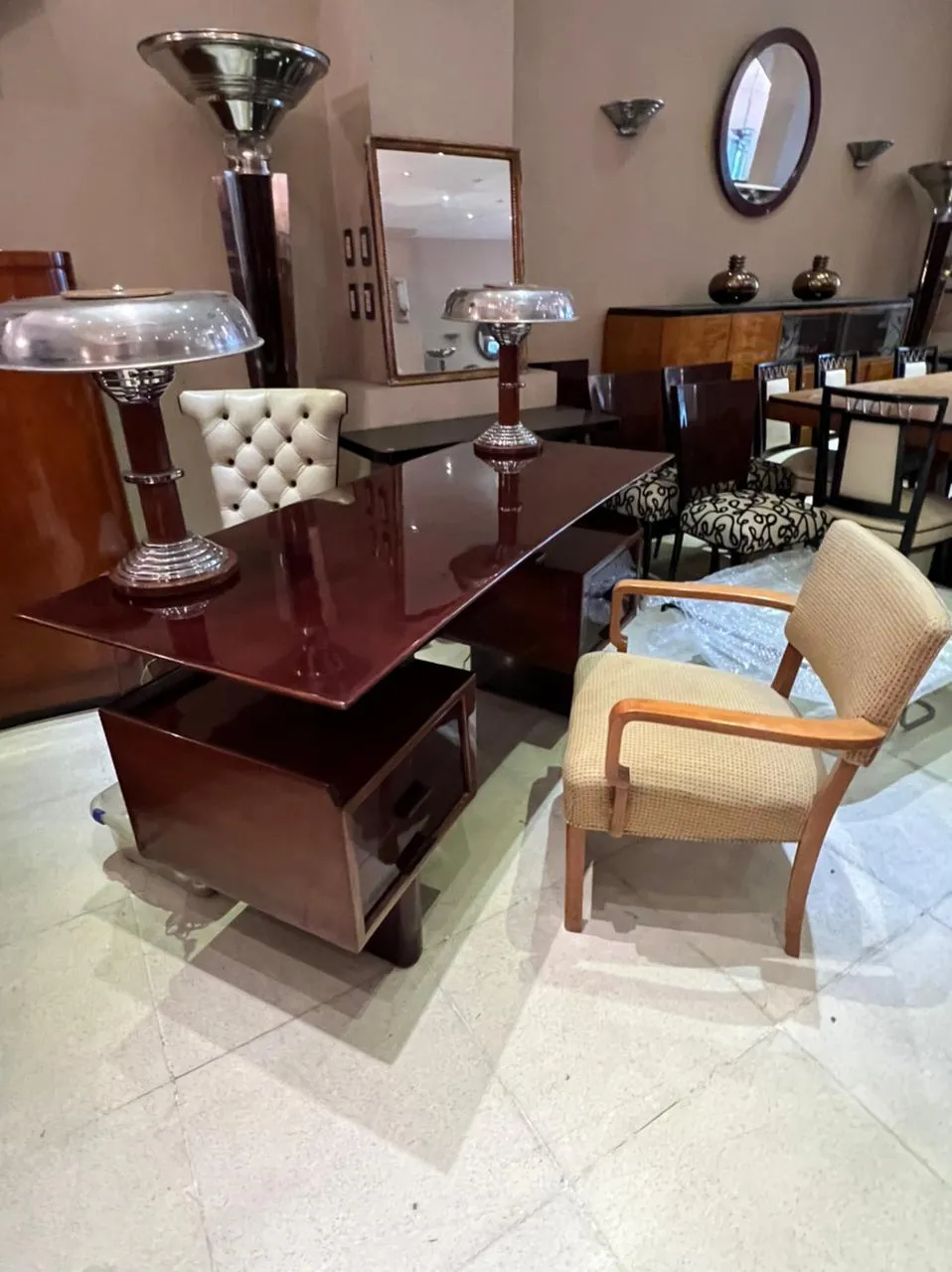 Antique desk with light fixtures, elegant interior, decorative chair.