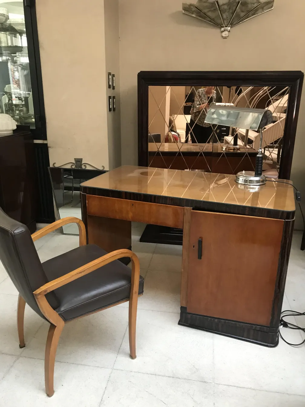 Antique desk with a mirror, features complementing the environment, matching chair.