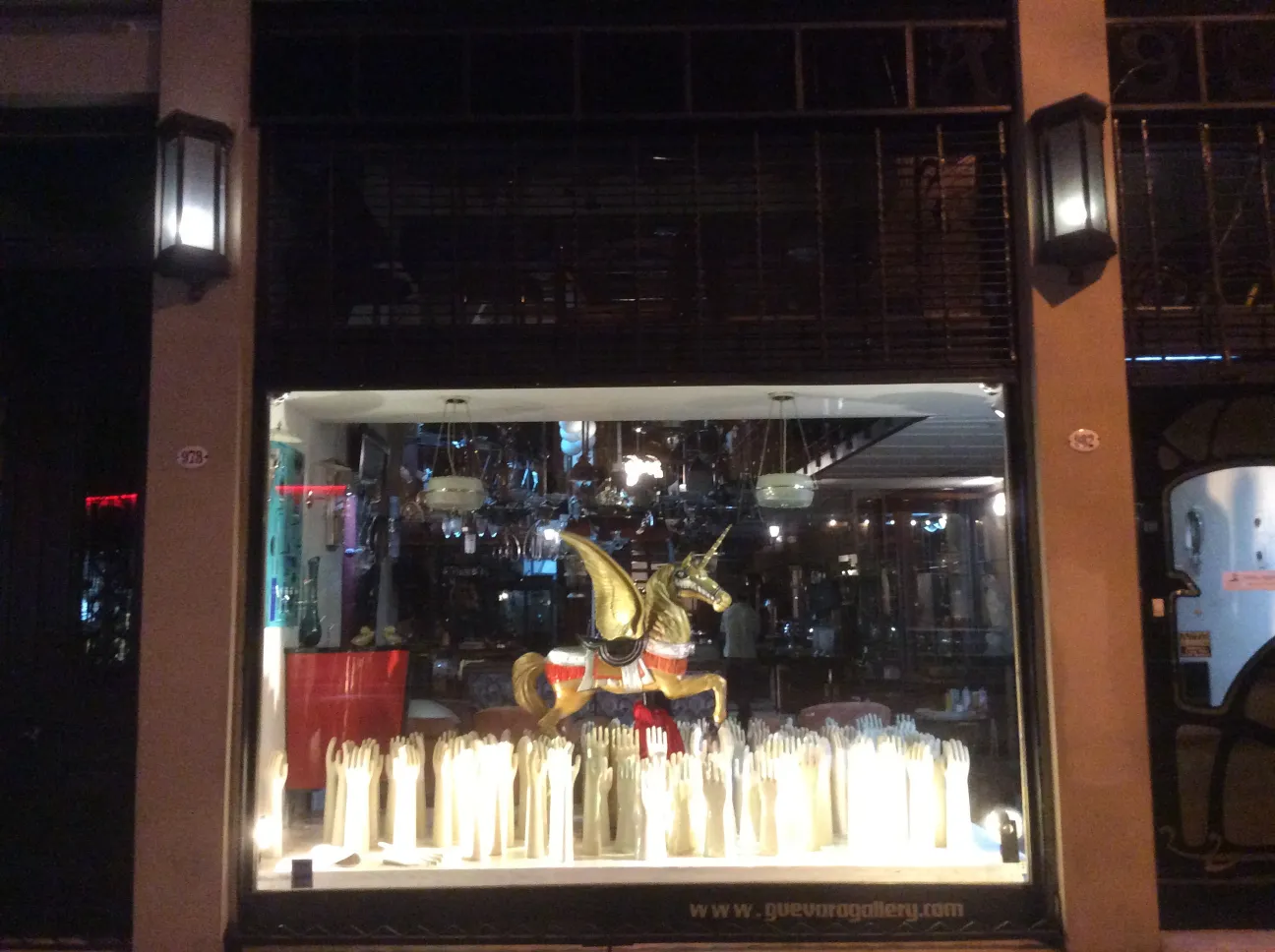 Showcase with antique ceramics and various decorations, including a golden unicorn.