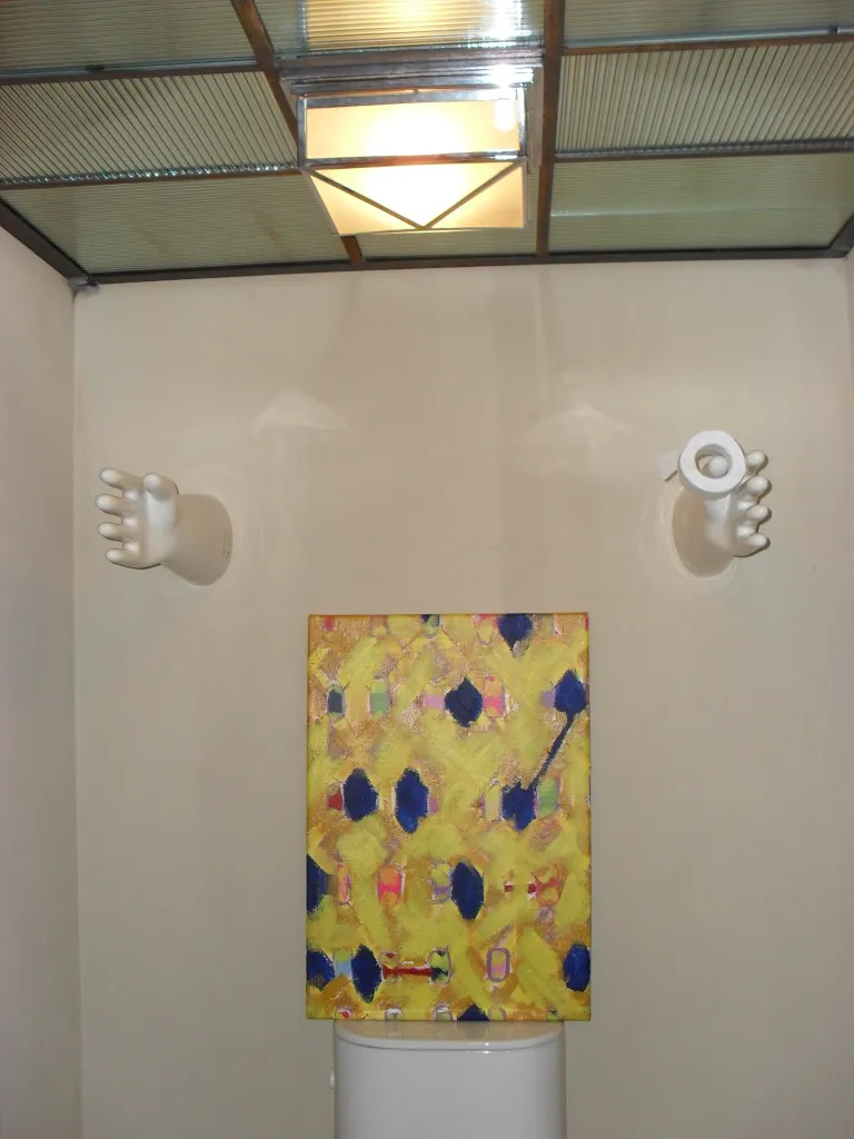 Antique decorative ceramic featuring hands in a modern setting.