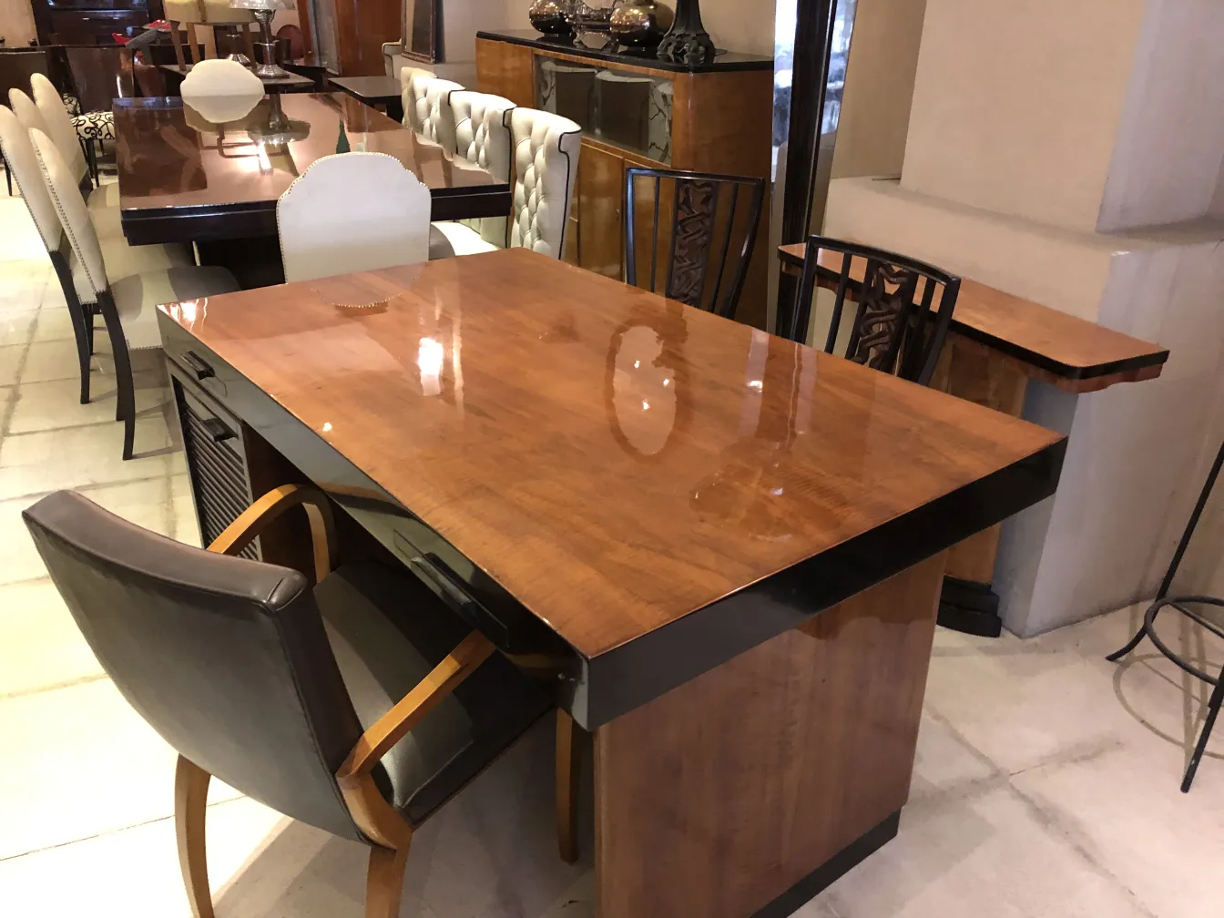 antique desk with a shiny finish and a chair
