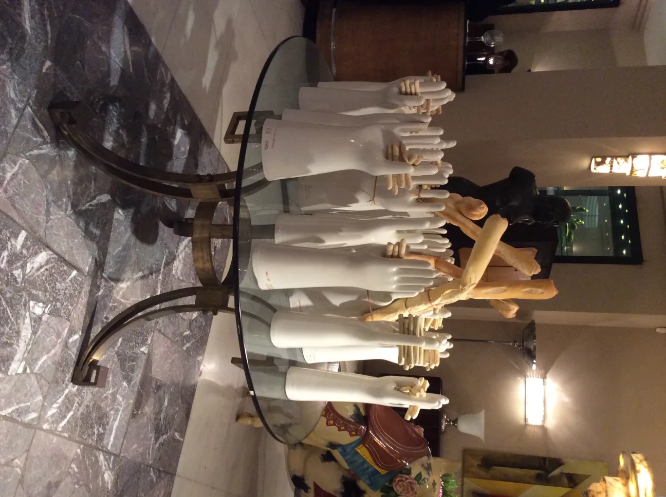 Set of ceramic hands displayed on a table.