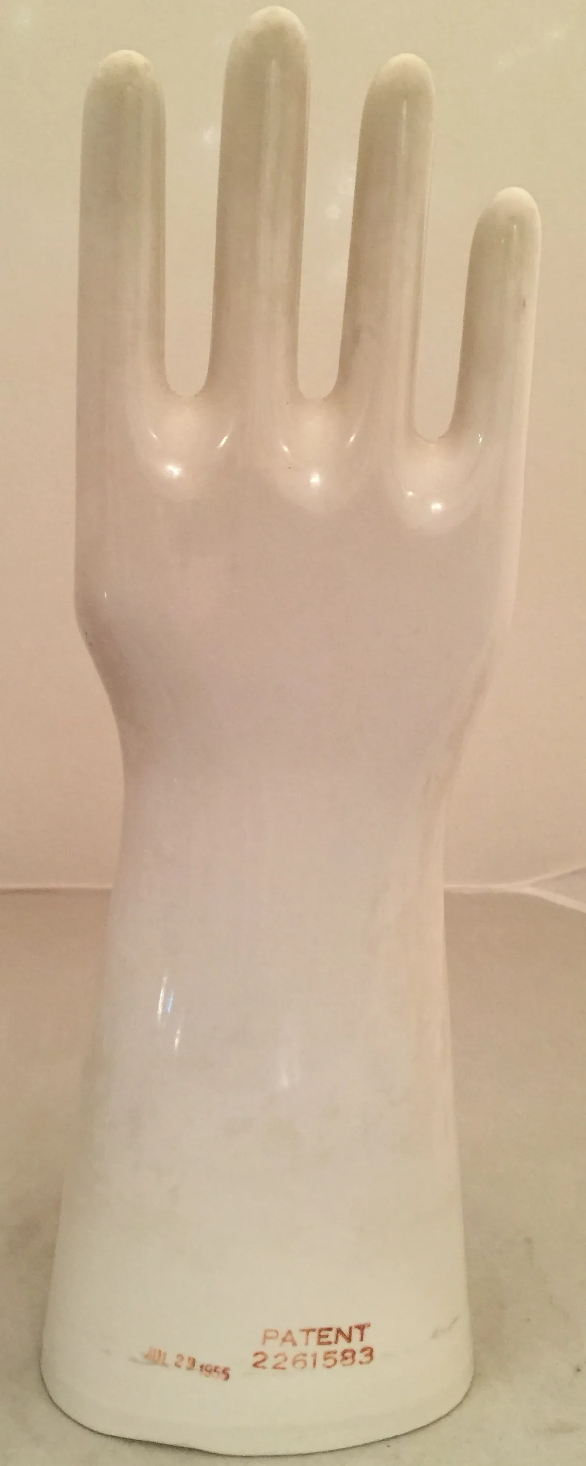 Antique white ceramic hand figure, minimalist design.