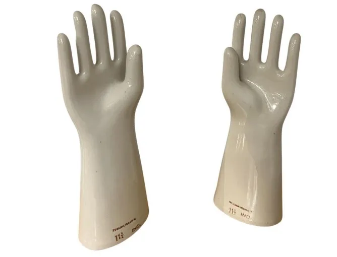 Two antique ceramic hands with decorative design.