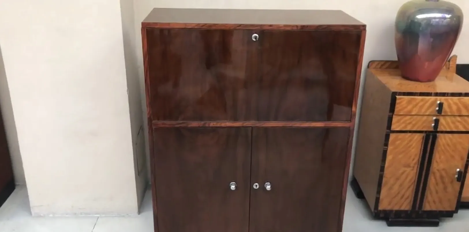 bureau ancien avec compartiments et surface lisse, entouré d'autres meubles