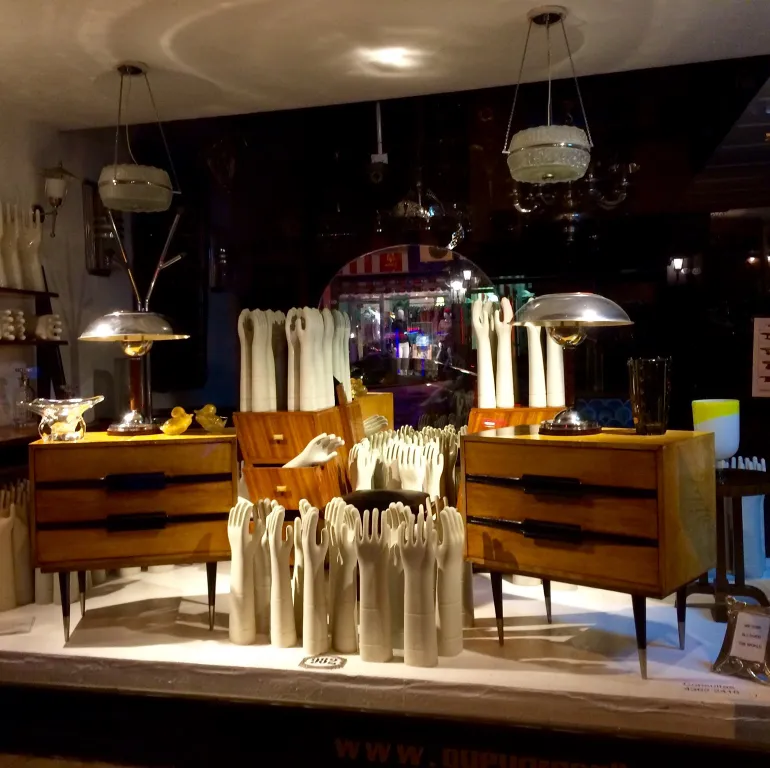 Display window featuring antique ceramic decorations and furniture