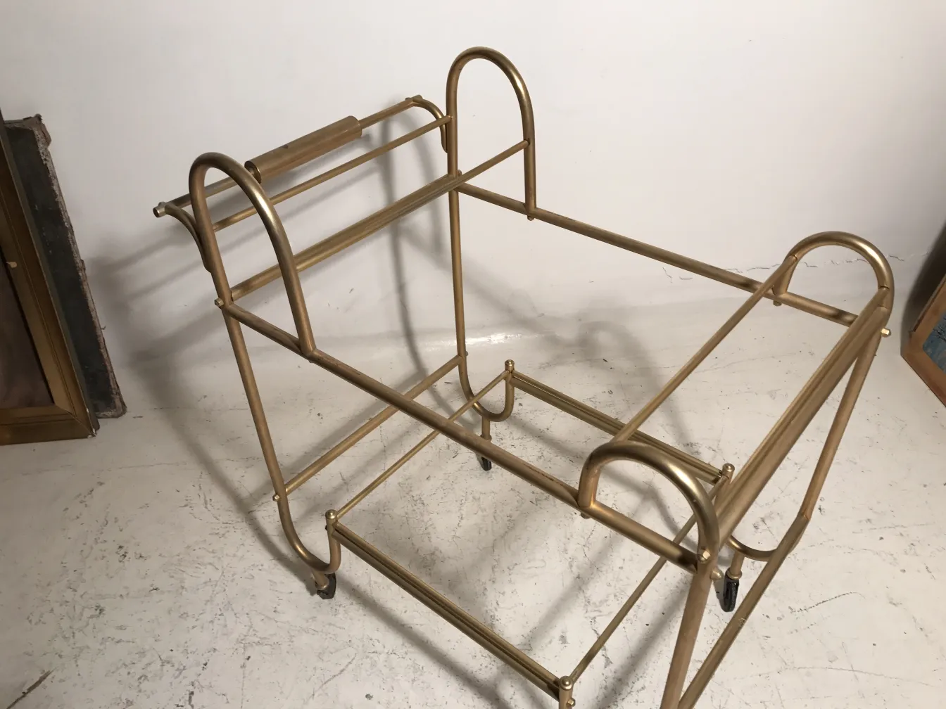 Antique cocktail trolley with golden frame and wheels