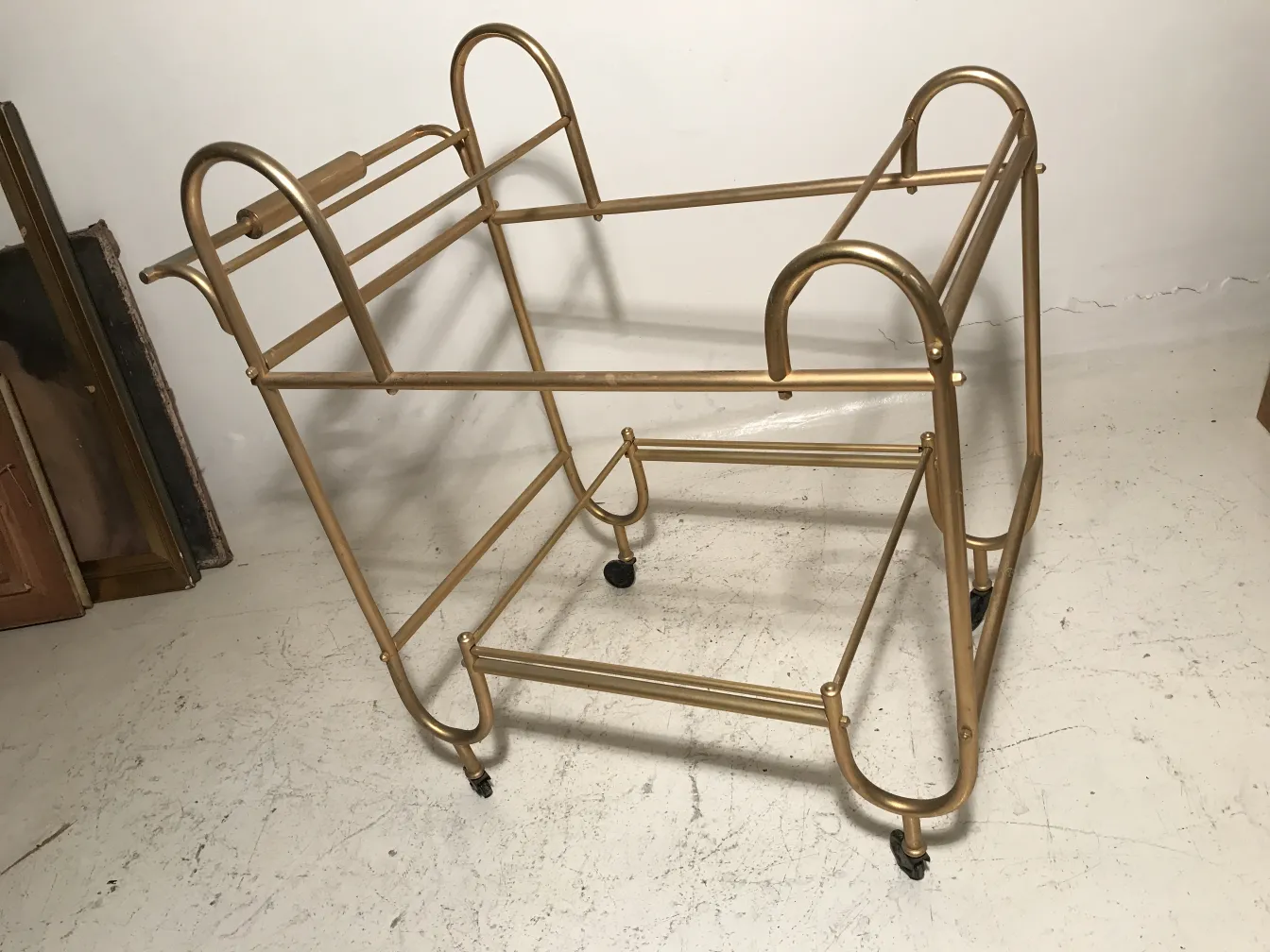 Antique golden metal cocktail trolley, ideal for serving drinks.