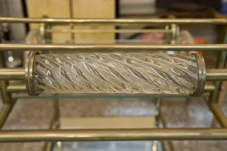 Detail of the handle on an antique cocktail trolley in an elegant setting.