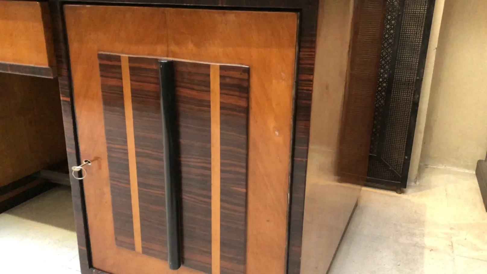 antique desk with decorative handles and polished finishes in a stylish environment