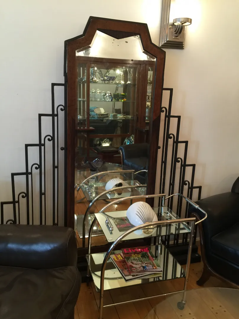 Antique cocktail trolley with a shiny mirror and magazines on top.