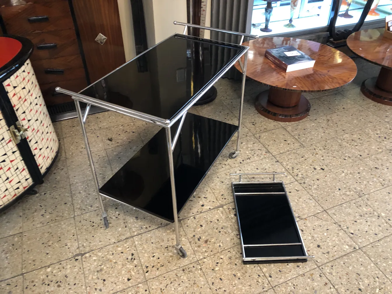 Antique cocktail trolley with black surface in a vintage setting
