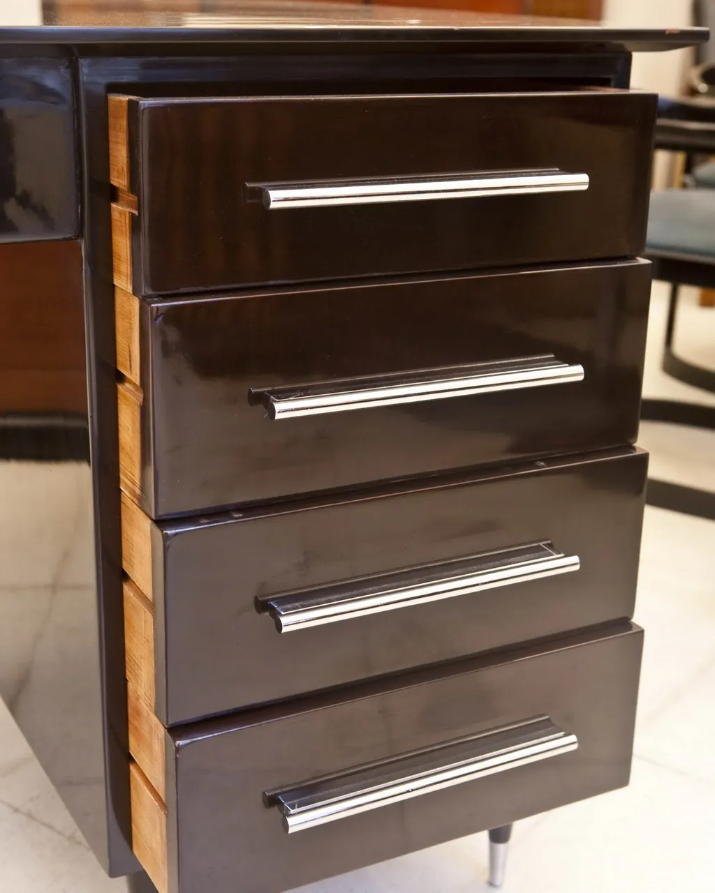 bureau ancien avec finition noire et bois clair, quatre tiroirs, cadre élégant