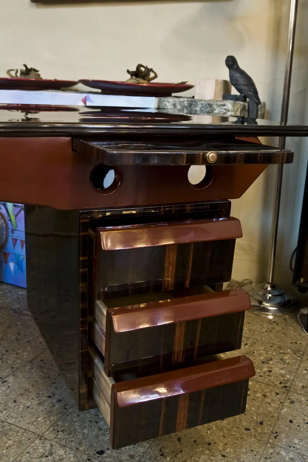 Antique desk with shiny finish and three drawers, decorated with figures