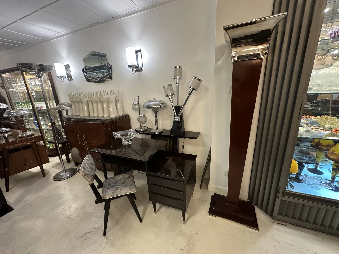 Black antique desk with stylish chairs, elegant ambiance.