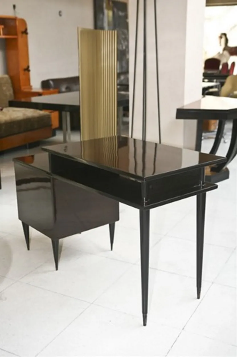 Antique desk with modern design and slender legs in an elegant setting.