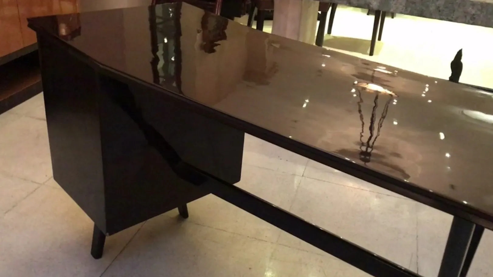 Bureau noir ancien avec finition brillante dans un cadre moderne.