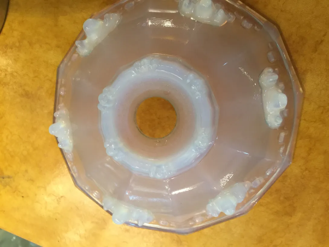 Lustre ancien, de couleur blanche, avec des détails décoratifs dans un style classique.