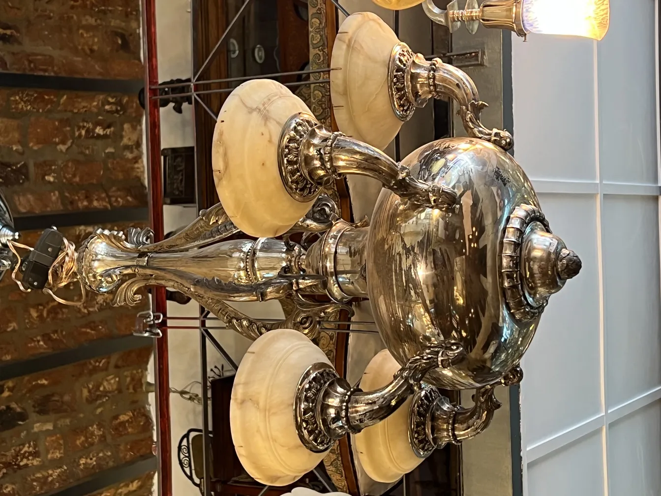 Lâmpada de teto antiga com braços decorativos e cúpulas.