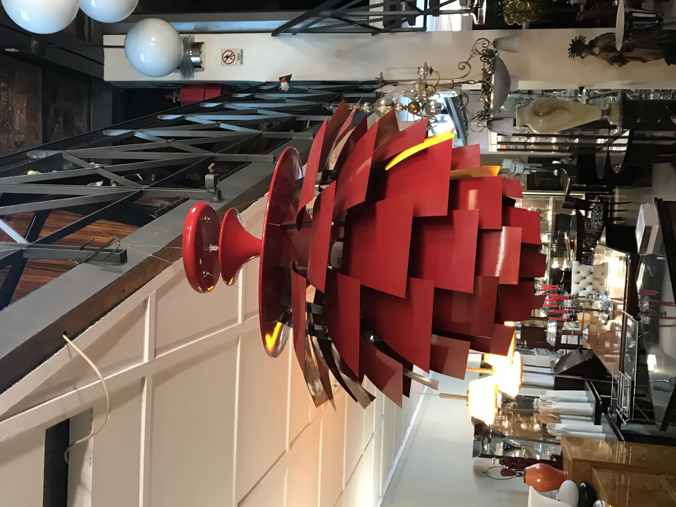 Antique hanging lamp with vibrant red design in an elegant setting.